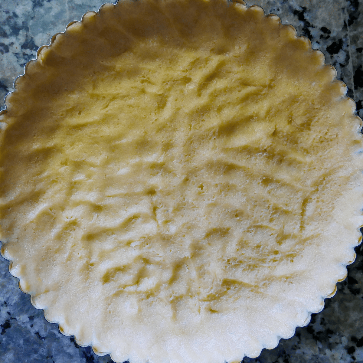 shortbread-crust-in-tart-pan.jpg Shortbread crust pressed into tart pan.