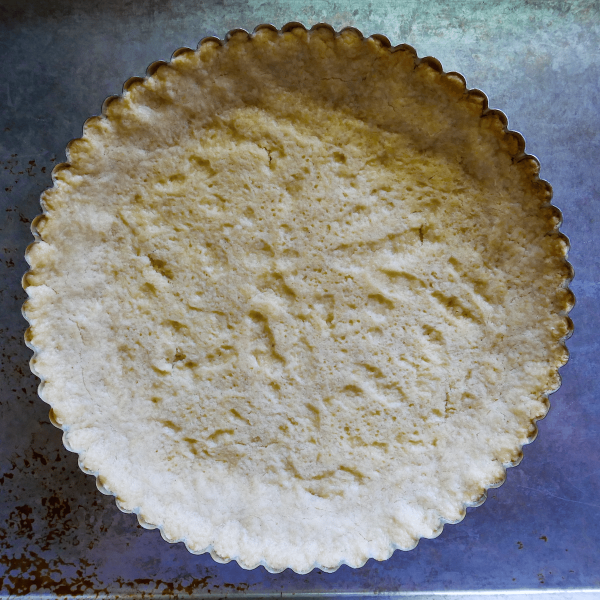 baked-shortbread-in-tart-pan.jpg baked shortbread crust in a tart pan.
