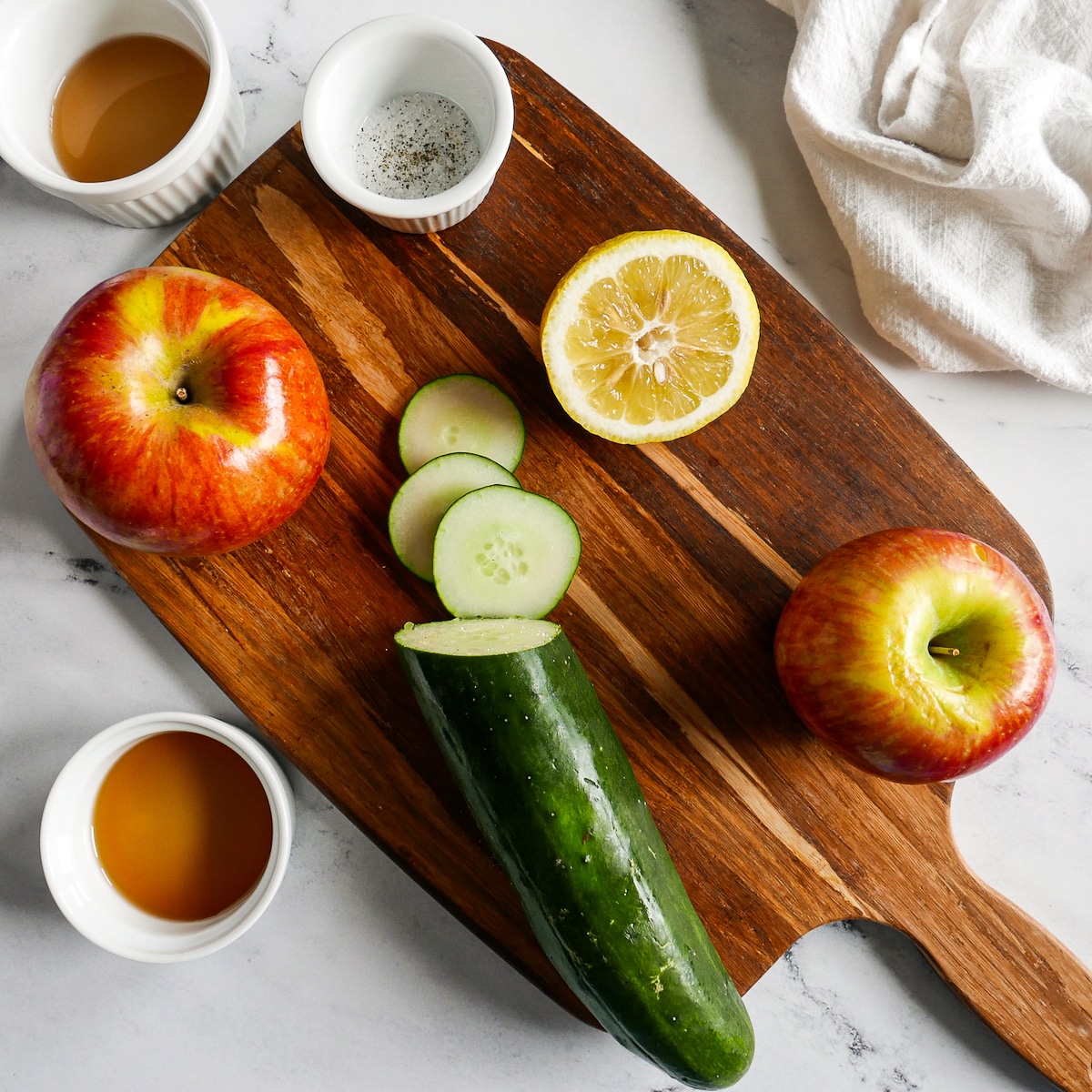 salad ingredients arranged on a wooden cutting board.