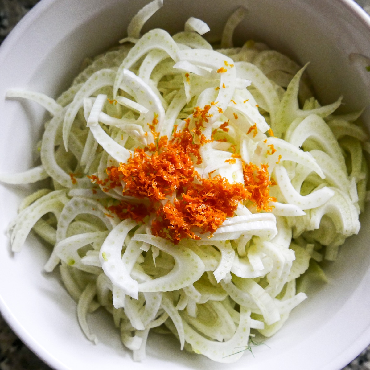shaved fennel in a mixing bowl.