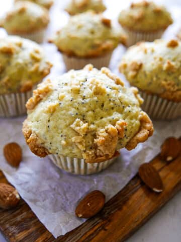 almond poppy seed muffins arranged on parchment paper.