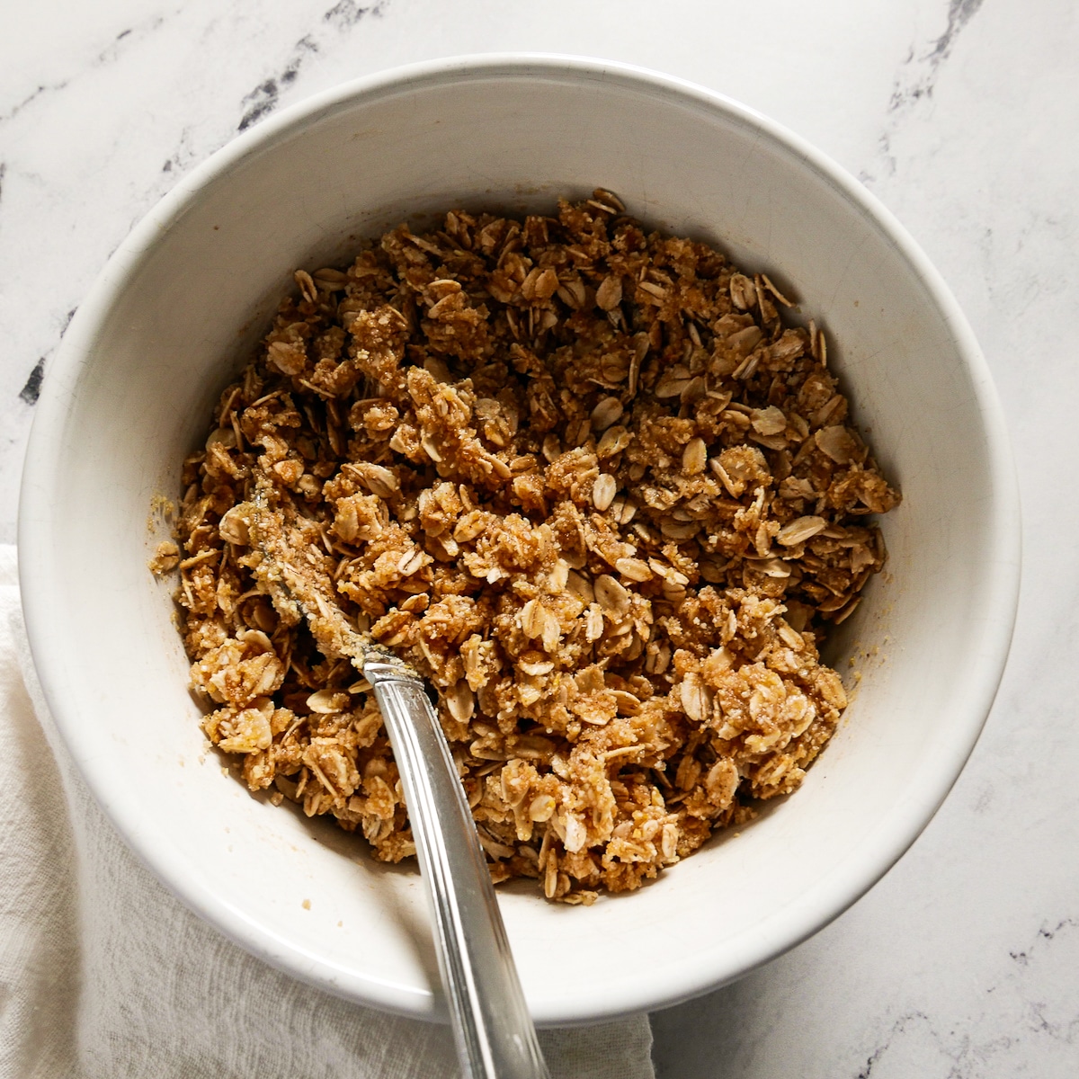 vegan butter and vanilla added to crisp mixture in a small bowl.