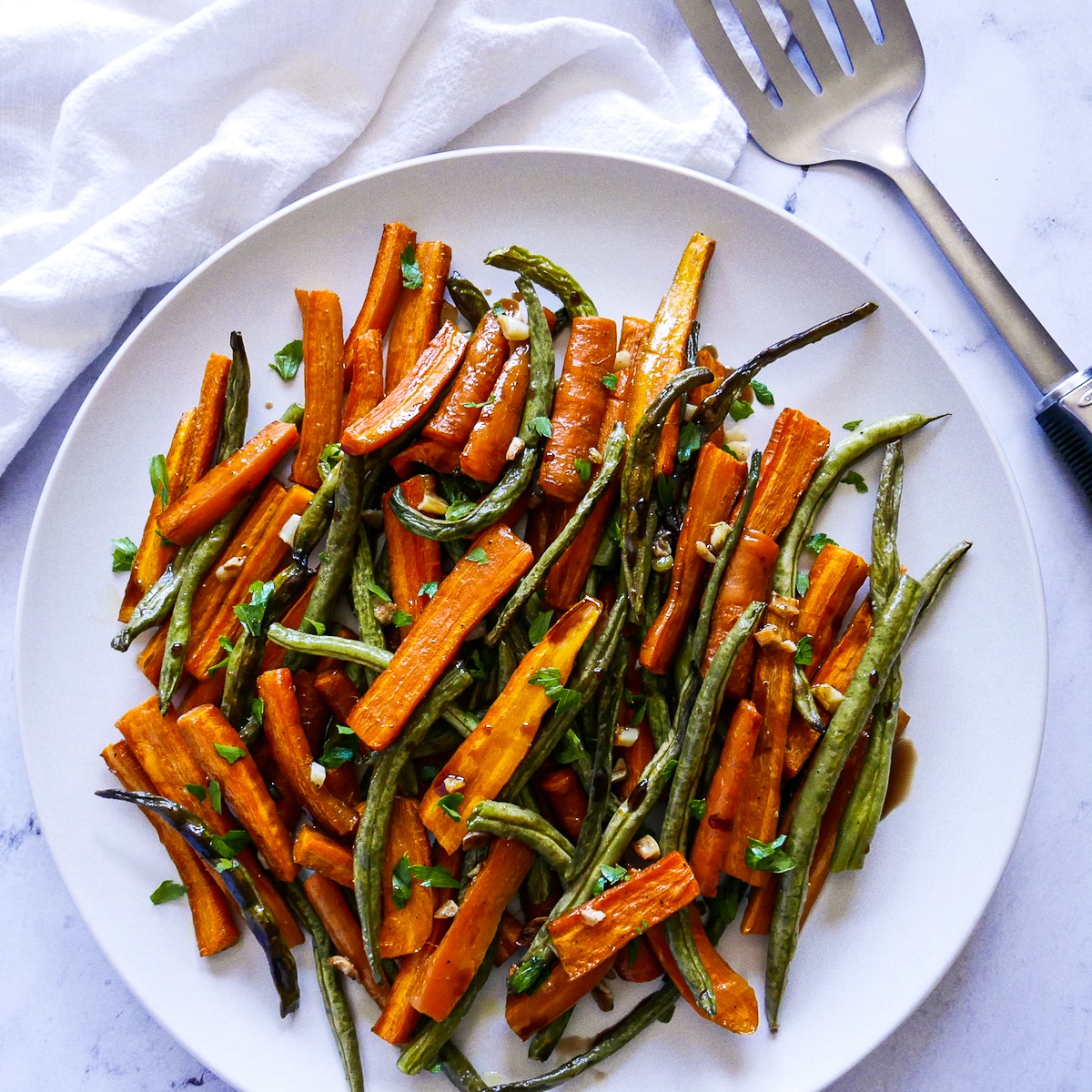 platter-of-roasted-vegetables.jpg platter of roasted vegetables with a spatula on the side.