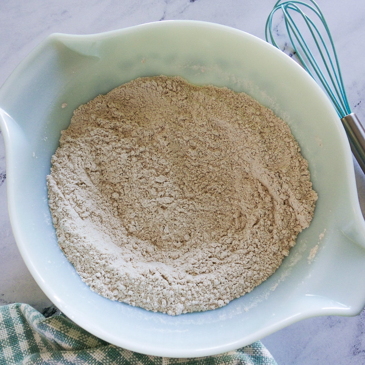 dry cake ingredients whisked together in a mixing bowl.