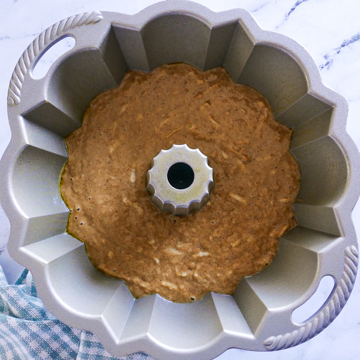 cake batter poured into prepared bundt pan.