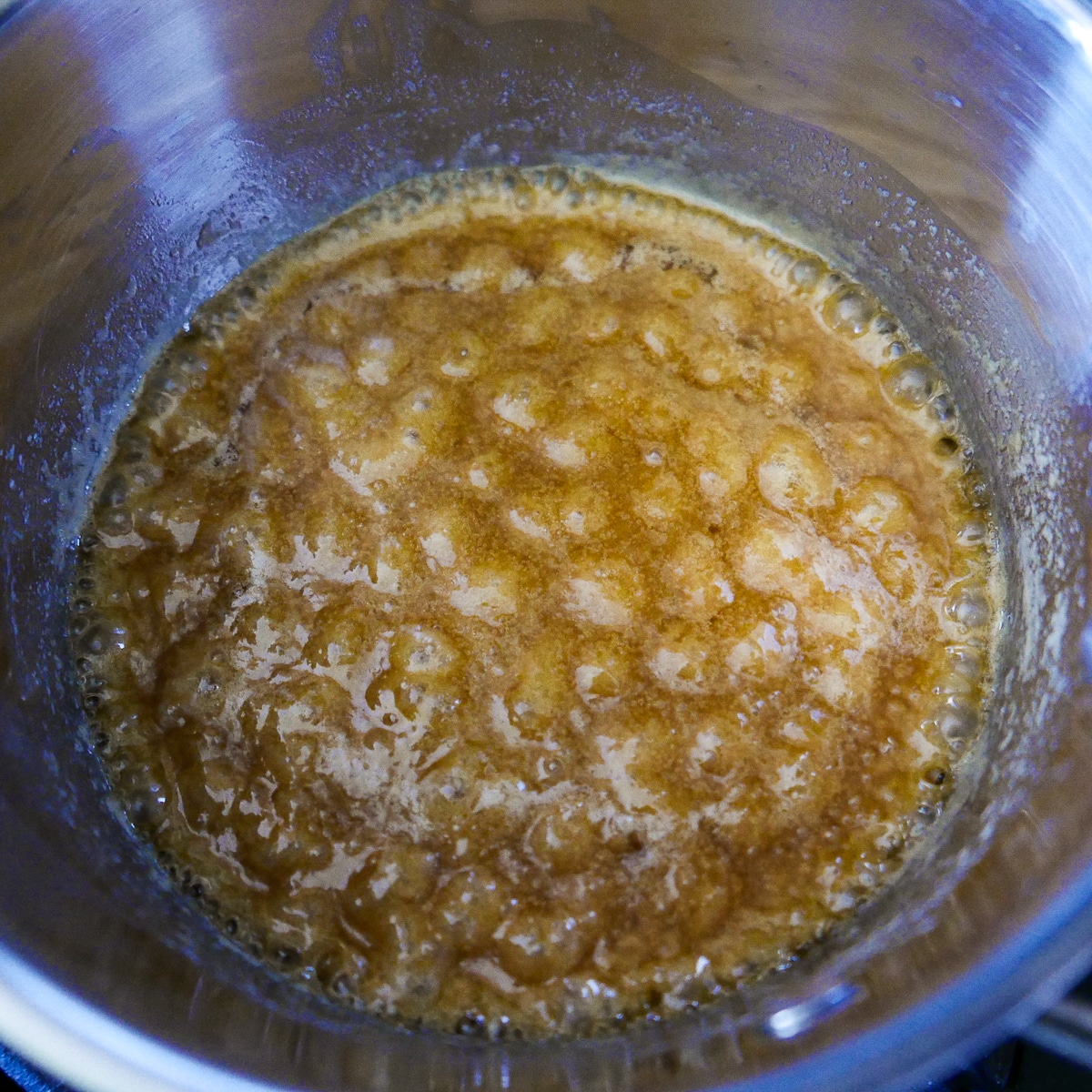 butter-and-brown-sugar-in-saucepan.jpg melted butter and brown sugar boiling in a saucepan.