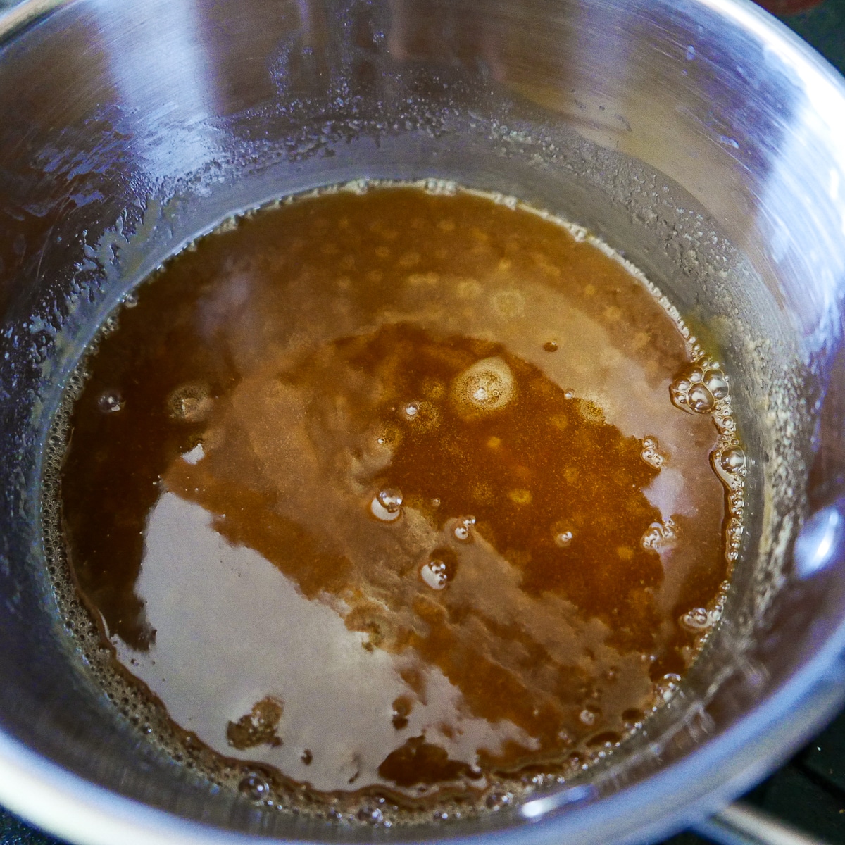 Milk, vanilla, and salt added to butter and sugar mixture in a saucepan. 