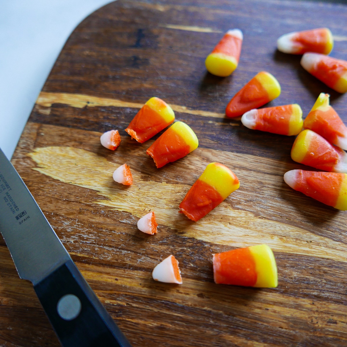 candy corn on a cutting board with the ends cut off.