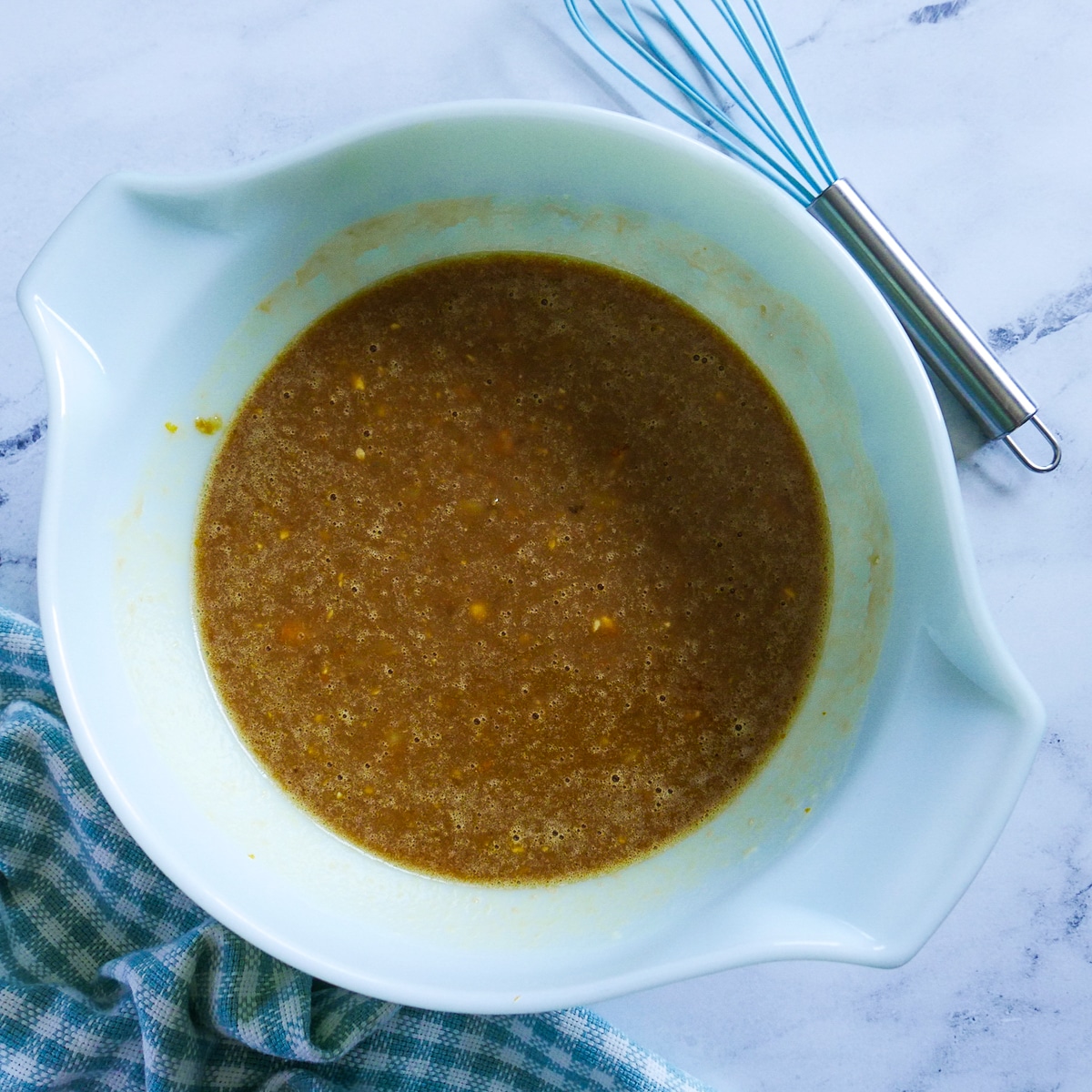 wet ingredients whisked together in a bowl.