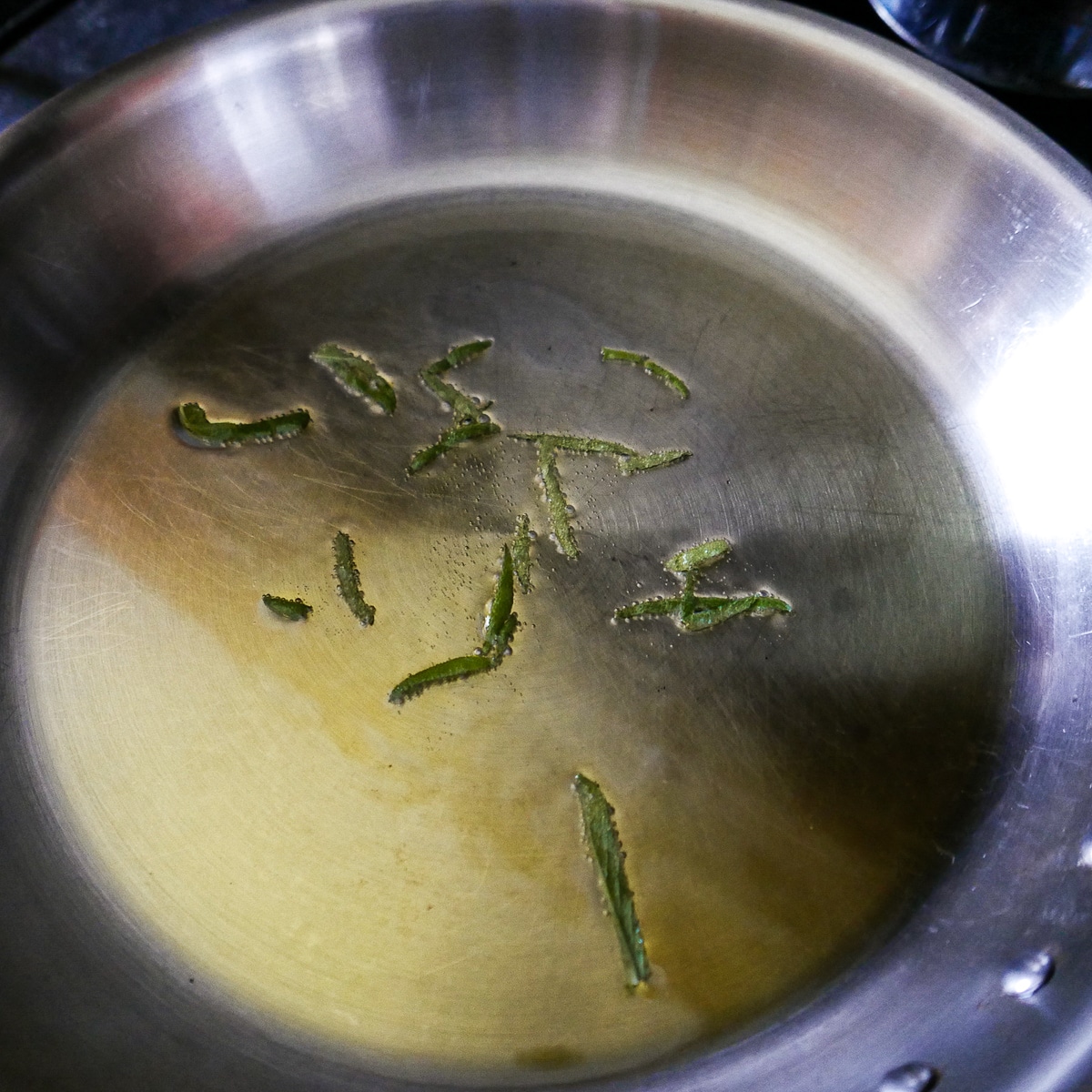sage being fried in a large skillet.