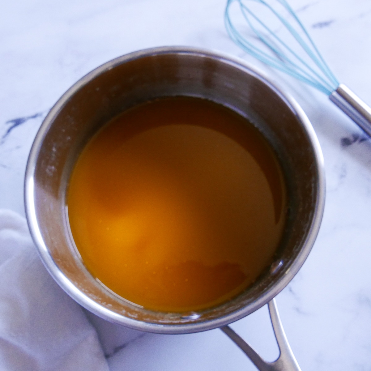 vegetable broth, pumpkin puree, and nutmeg whisked in a saucepan.