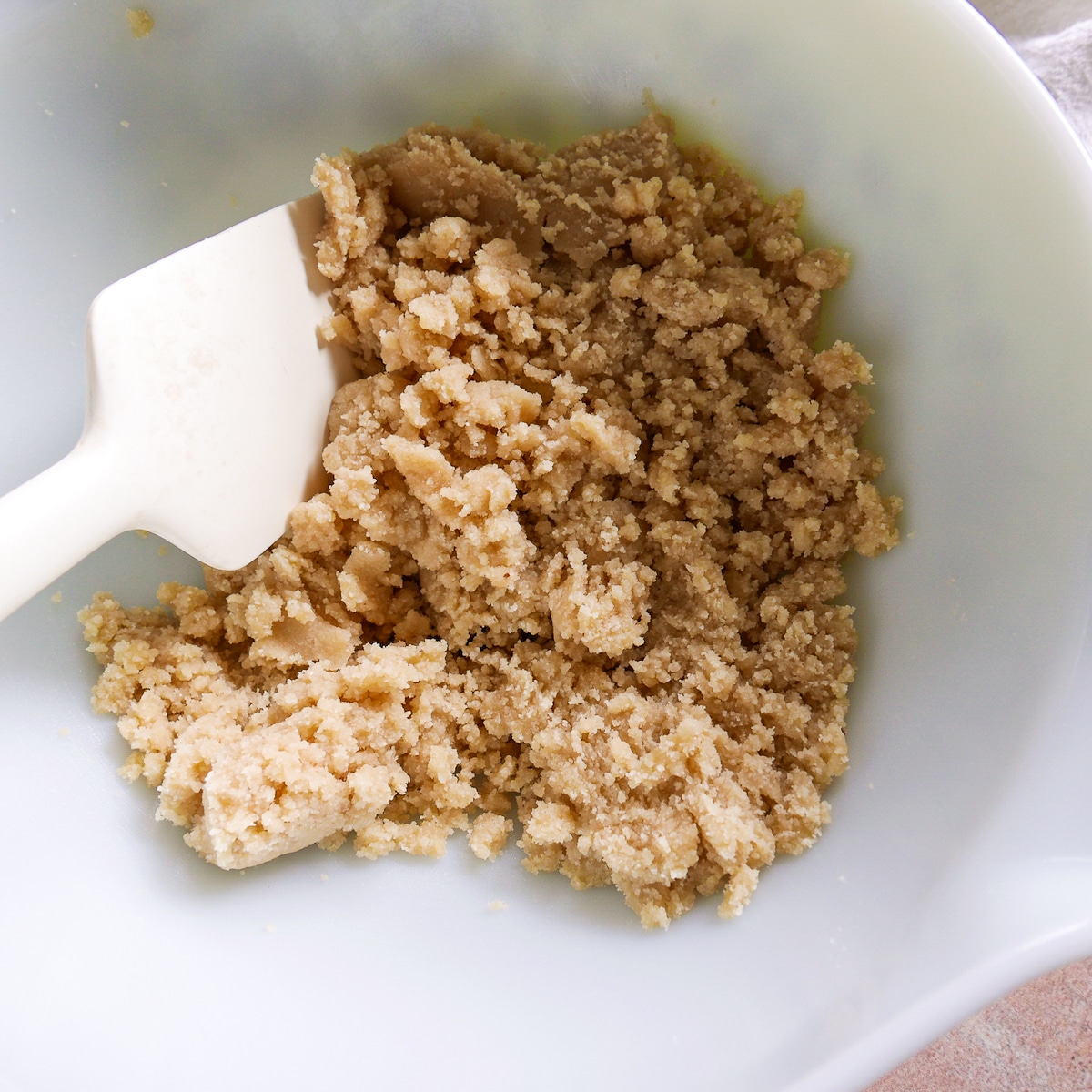 cookie dough in a bowl with a rubber spatula.