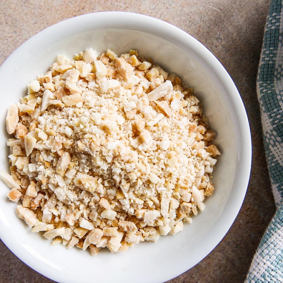 small white bowl of crushed slivered almonds.