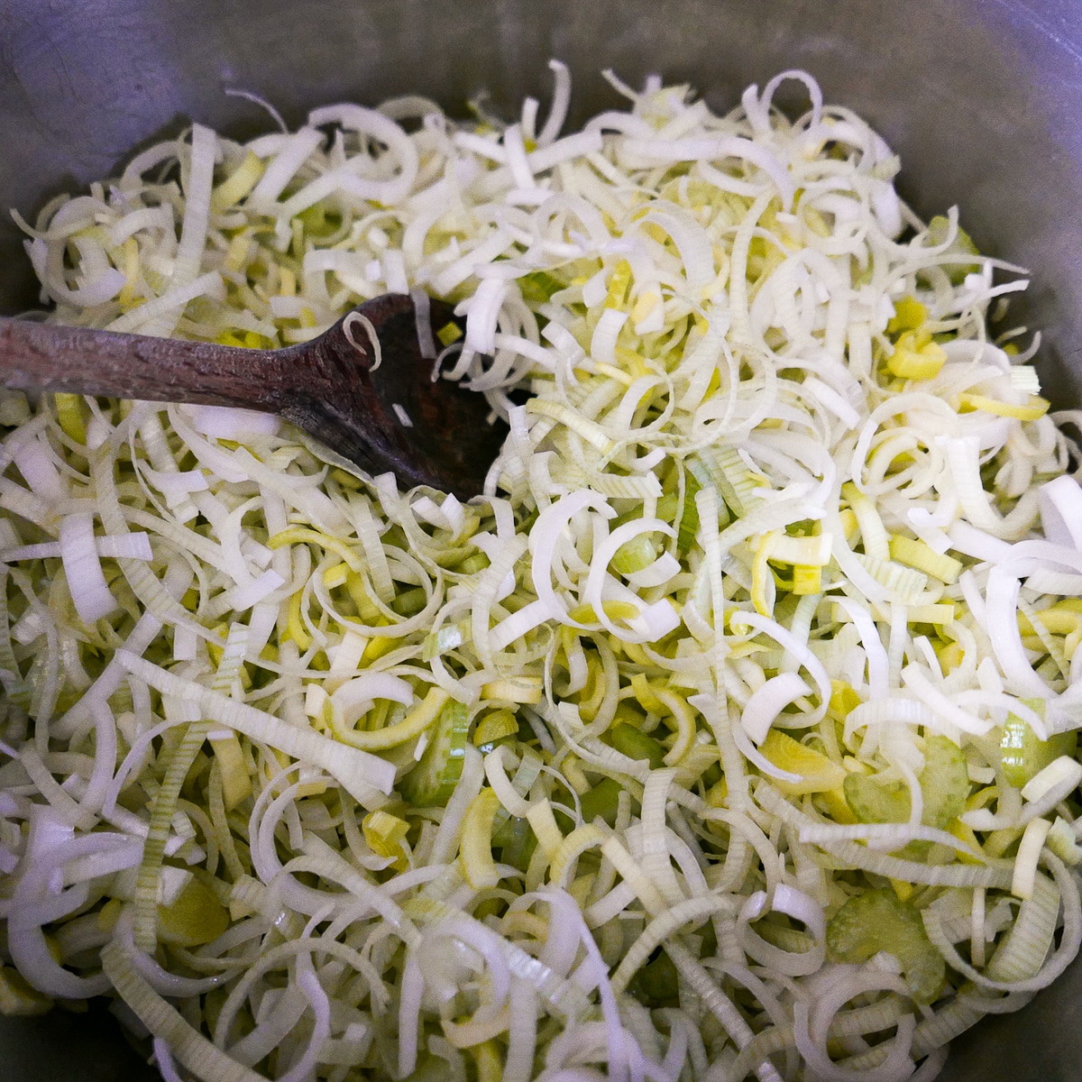 vegetables-cooking-in-pot.jpg sliced leeks, celery, and garlic cooking in a large pot.