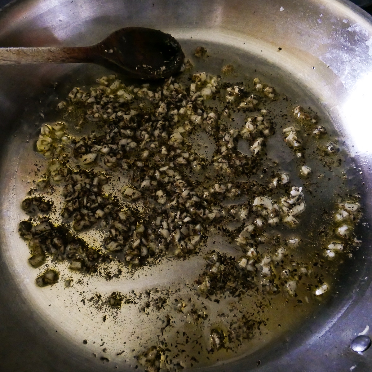 garlic-and-herbs-in-skillet.jpg garlic and dried herbs added to hot skillet.