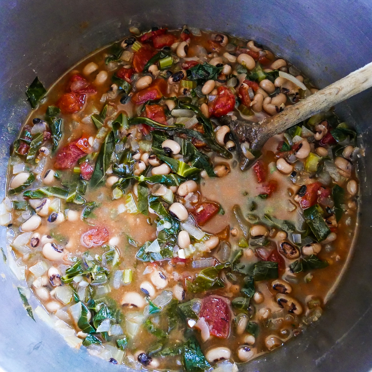 soup-cooking.jpg tomatoes, peas, and broth added to mixture in pot.