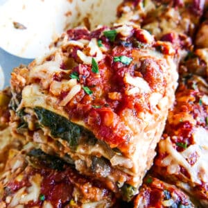 slice of no boil lasagna being lifted from baking dish.