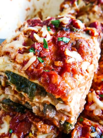 slice of no boil lasagna being lifted from baking dish.