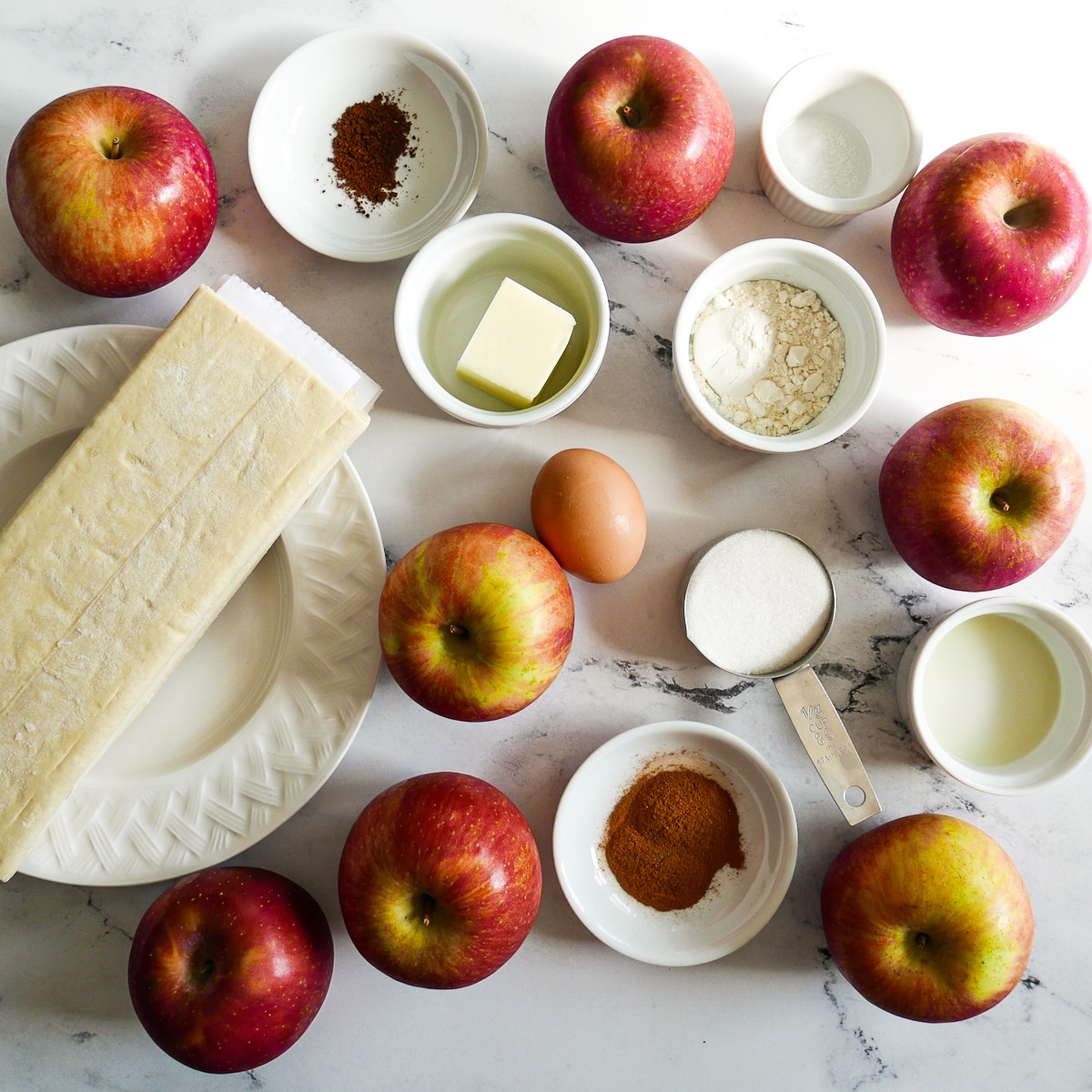 apple pie ingredients arranged on a table.