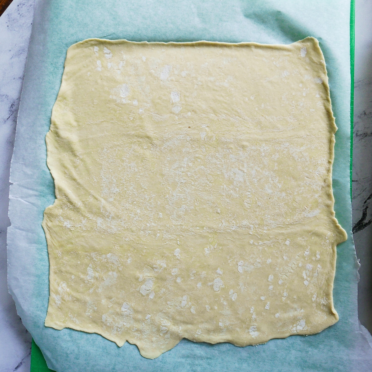 sheet of puff pastry rolled out on floured surface.