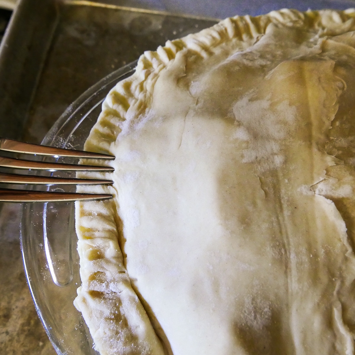 fork pressing around rim of puff pastry crust.