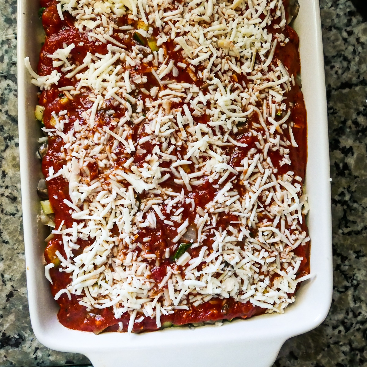 assembled lasagna in a baking dish and ready to go in the oven.