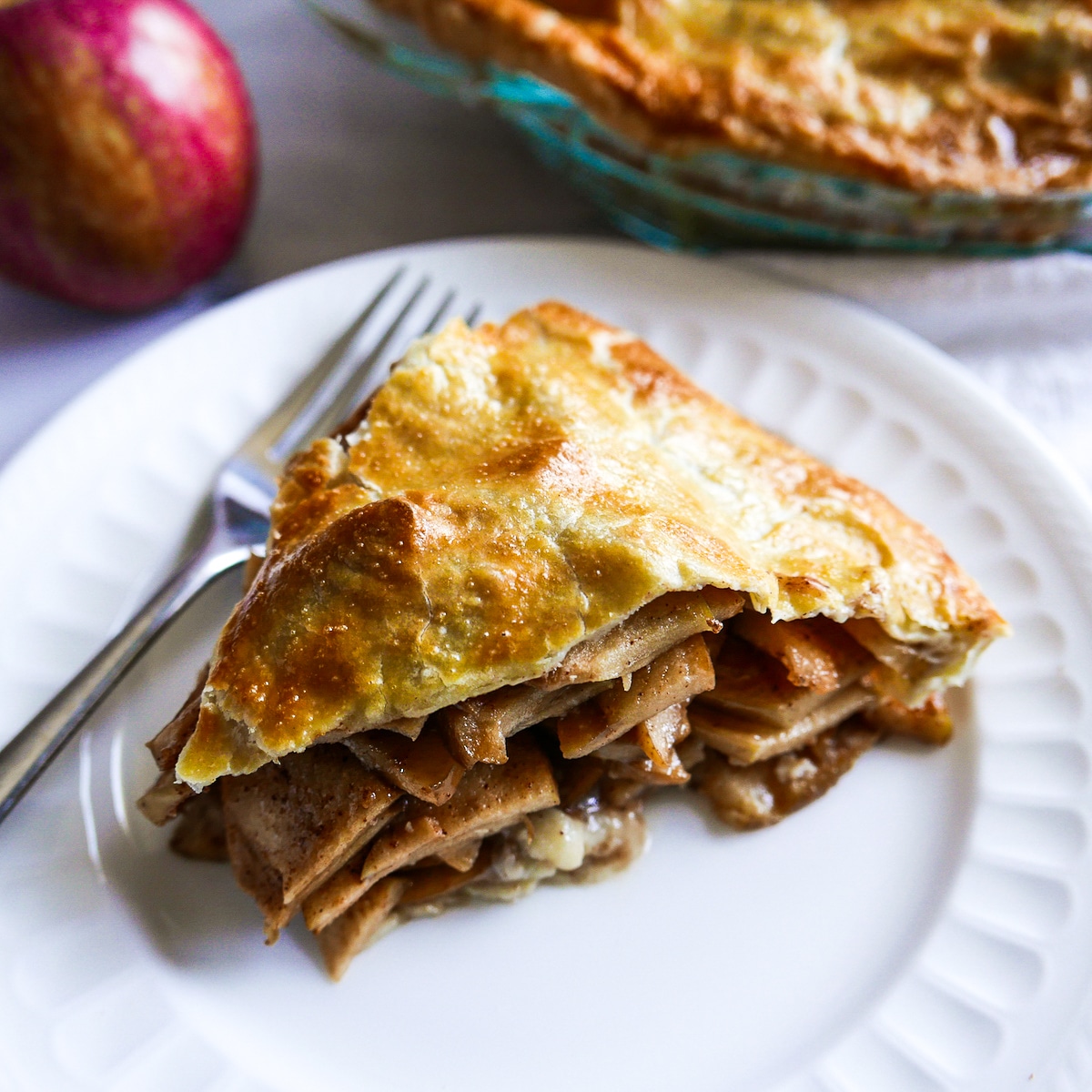slice-of-apple-pie.jpg slice of apple pie with fork on a white plate.