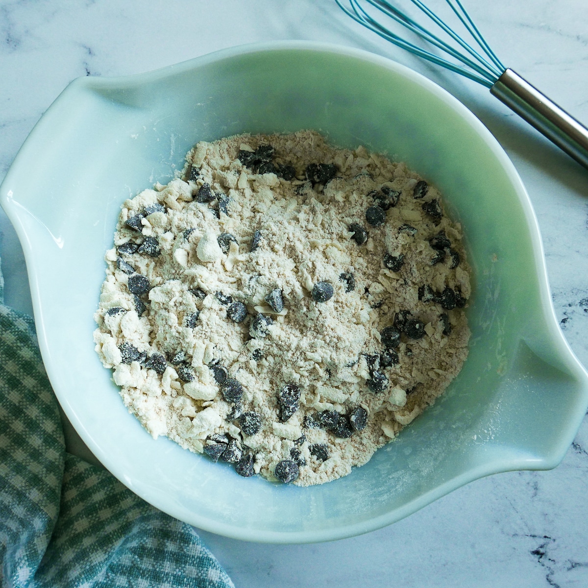chocolate-chips-mixed-in.jpg chocolate chips stirred into flour and butter mixture.