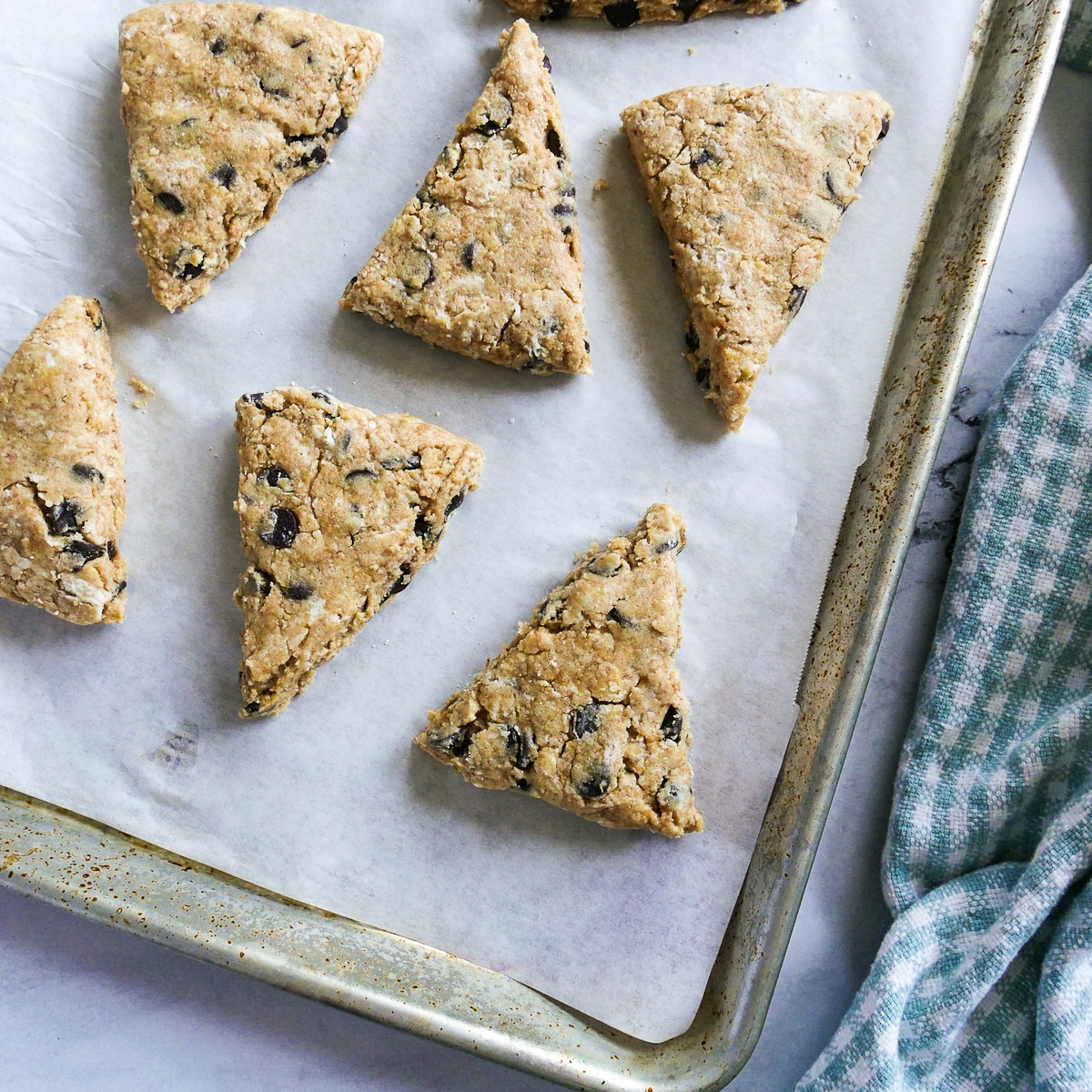 scone wedges placed on a parchment lined baking sheet.