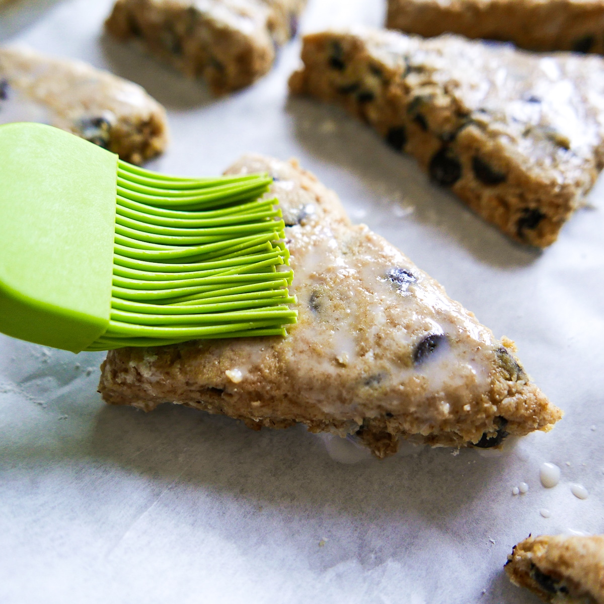 brushing-heavy-cream-on-scones.jpg brushing heavy cream on tops of scones.