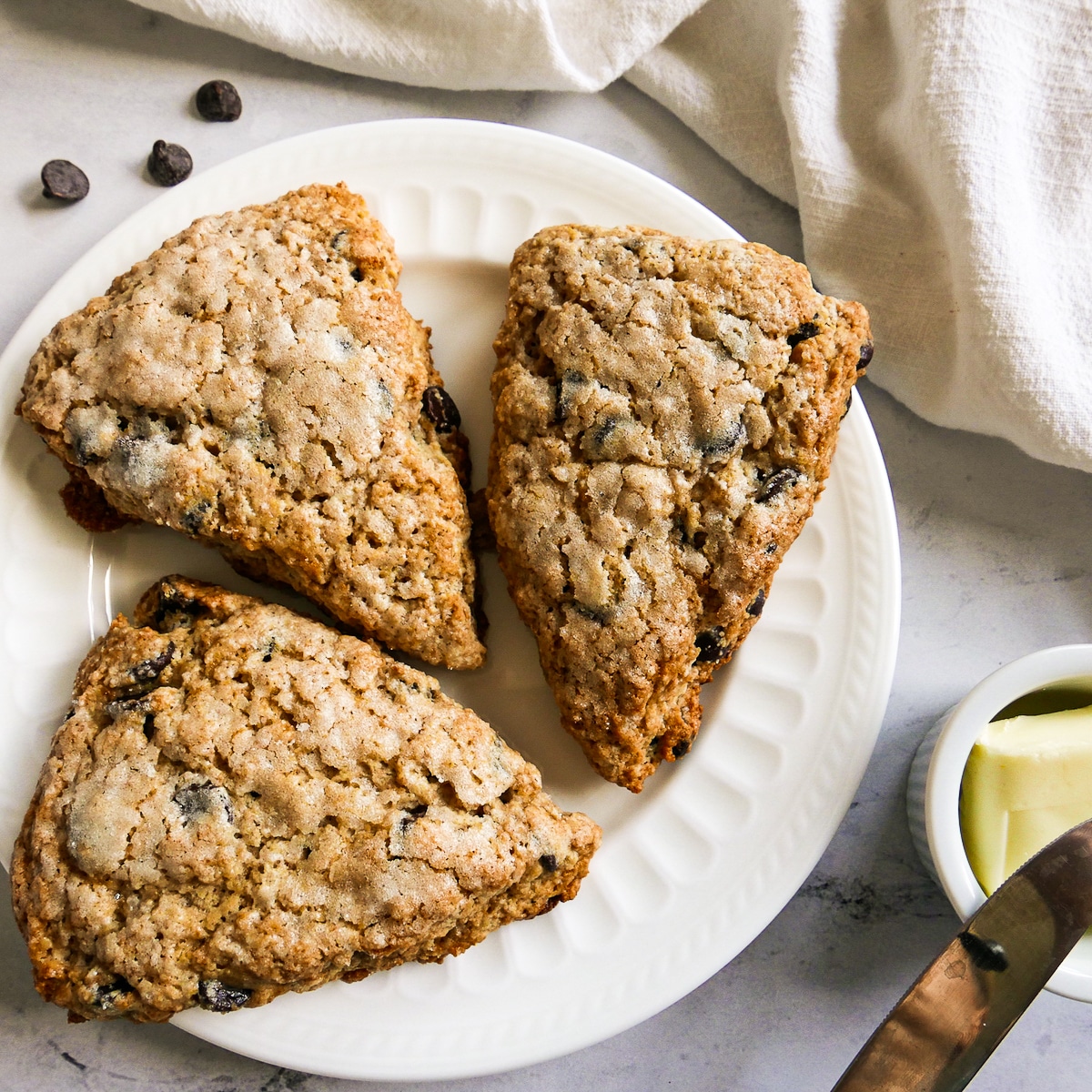 three-scones-on-plate.jpg three sourdough scones arranged on a white plate with white napkin.