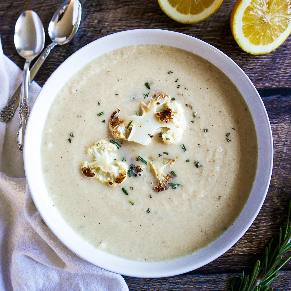 soup-with-roasted-cauliflower.jpg Bowl of roasted cauliflower soup garnished with rosemary.