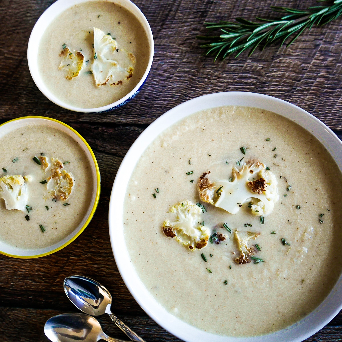 three-bowls-of-cauliflower-soup.jpg Three bowls of cauliflower soup garnished with rosemary.