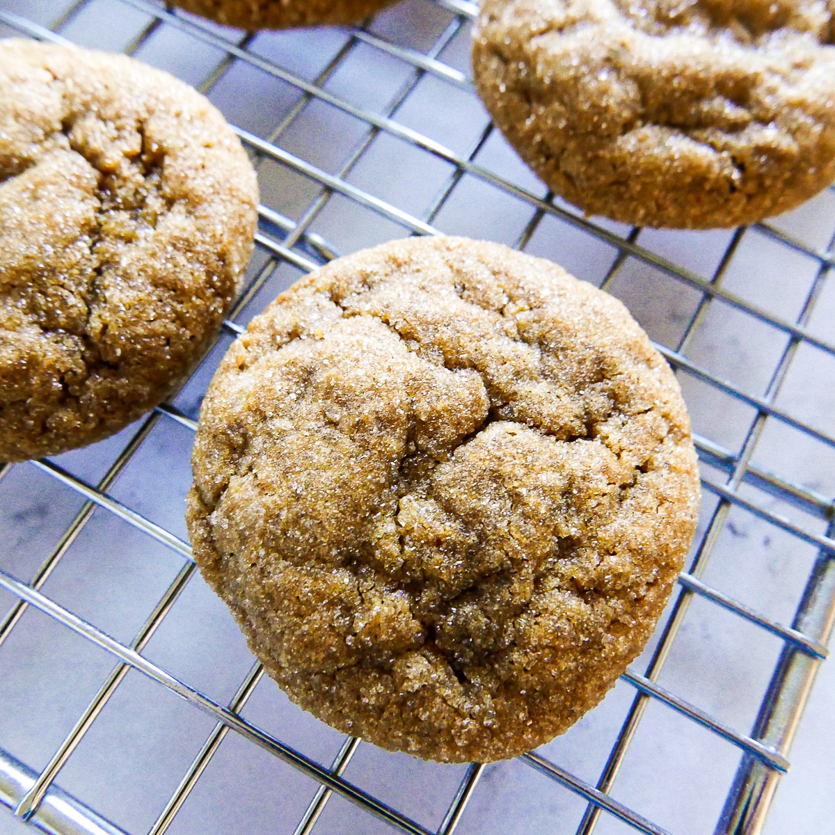 gingersnaps resting on a cooling rack.