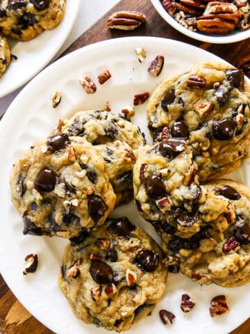 plate of pecan chocolate chip cookies with chopped pecans.