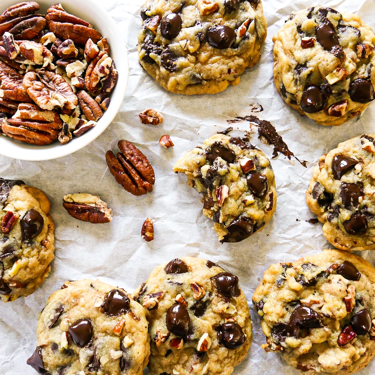 pecan-cookies-on-parchment.jpg pecan cookies arranged on parchment paper.