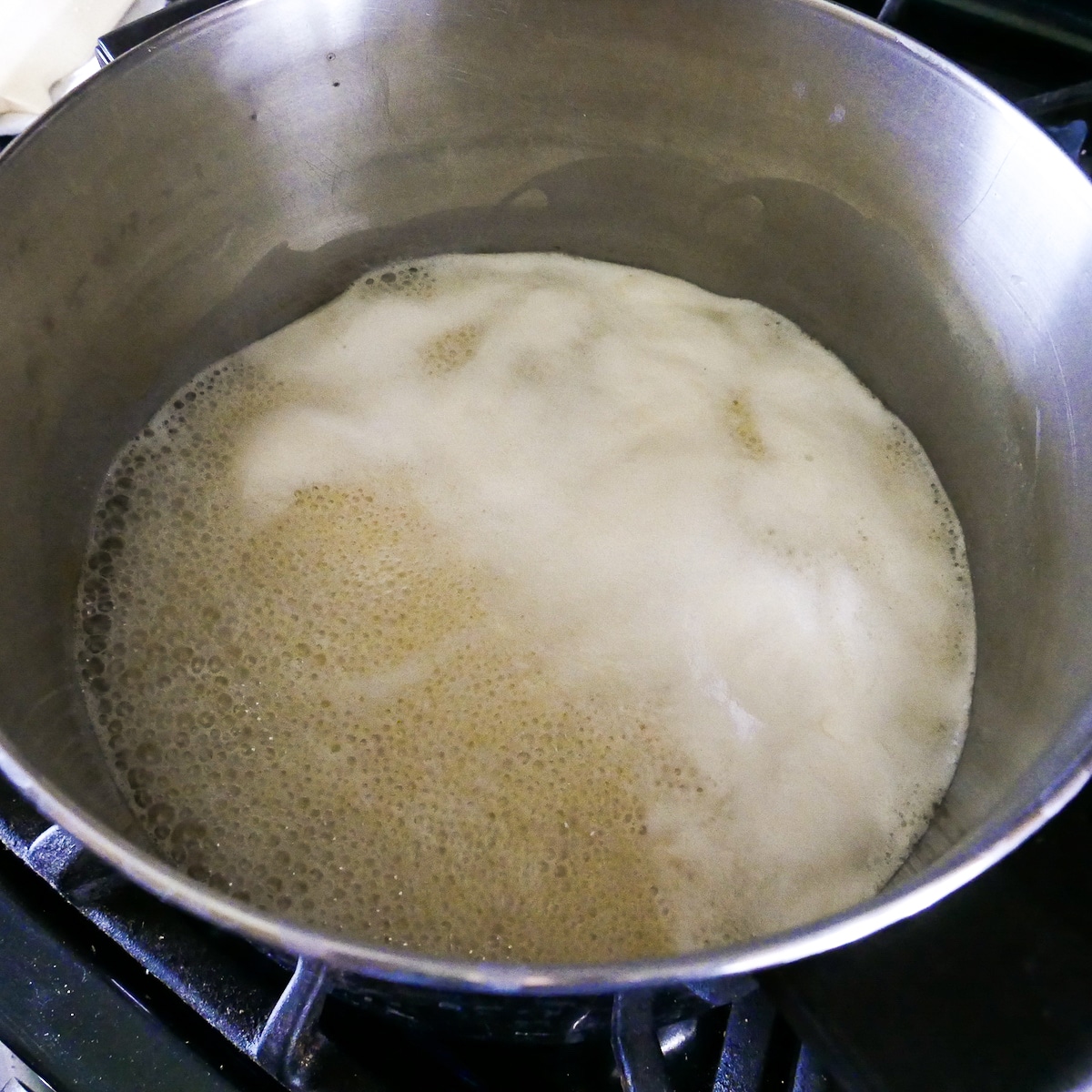 caramel ingredients cooking in a large pot.