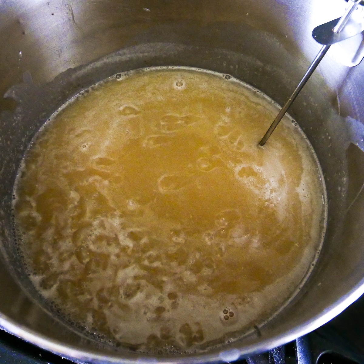 caramel cooking with a candy thermometer.