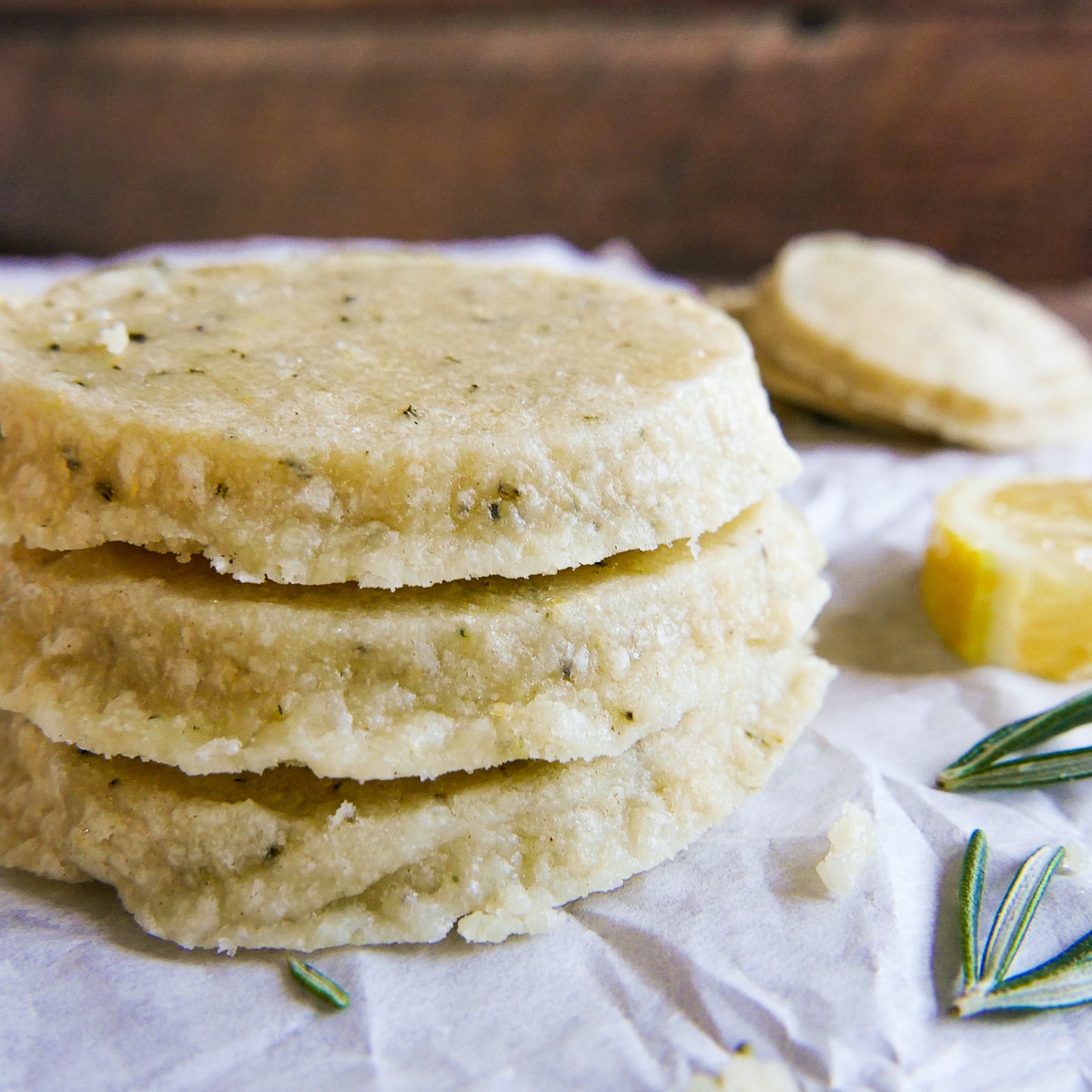 stack of lemon shortbread cookies on parchment paper.