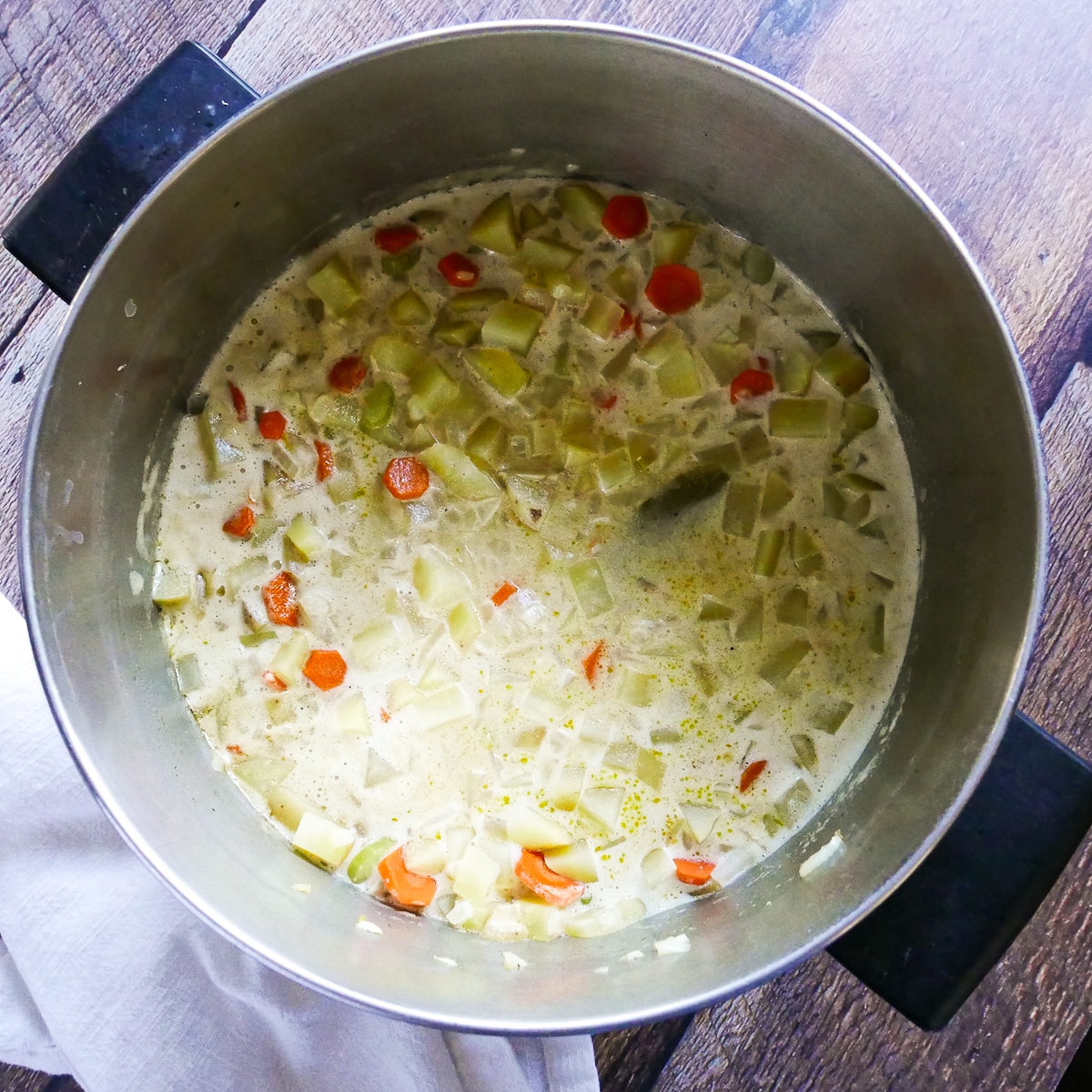 broth, potatoes, and coconut milk added to soup.