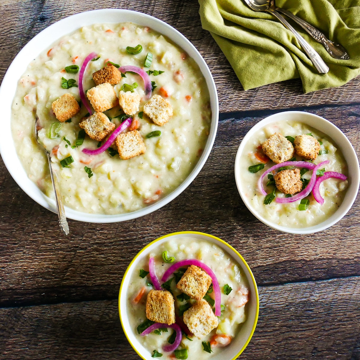 vegan potato soup on a table with croutons.