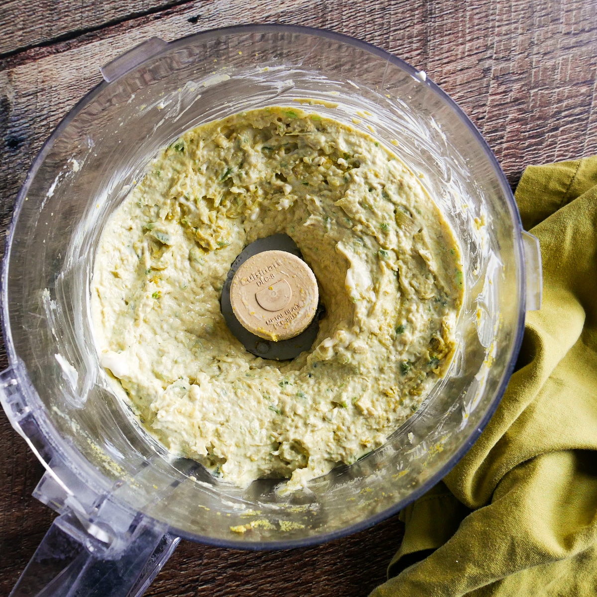 dip ingredients blended in a food processor with a napkin on the side.