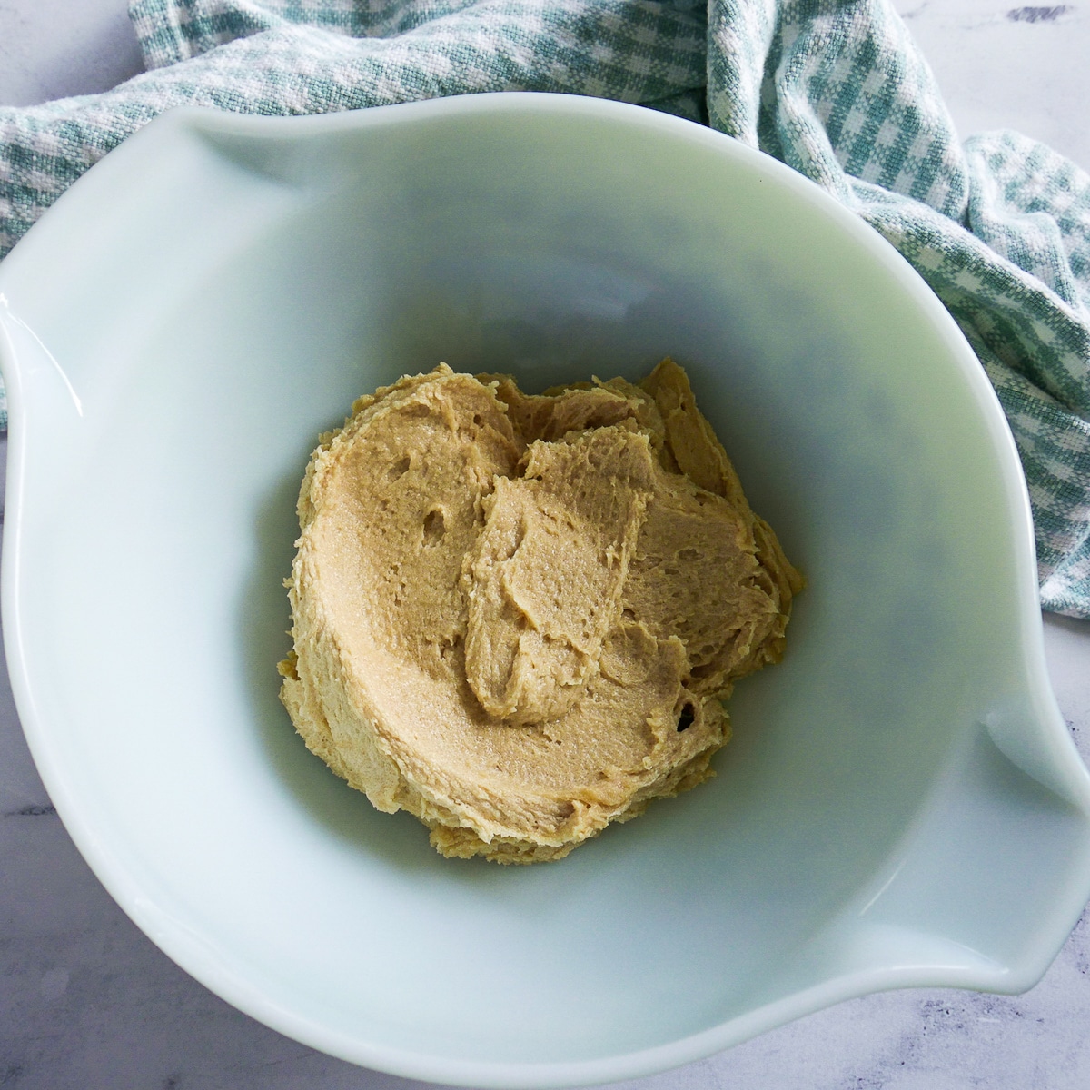 butter and sugars creamed together in the bowl of a stand mixer.