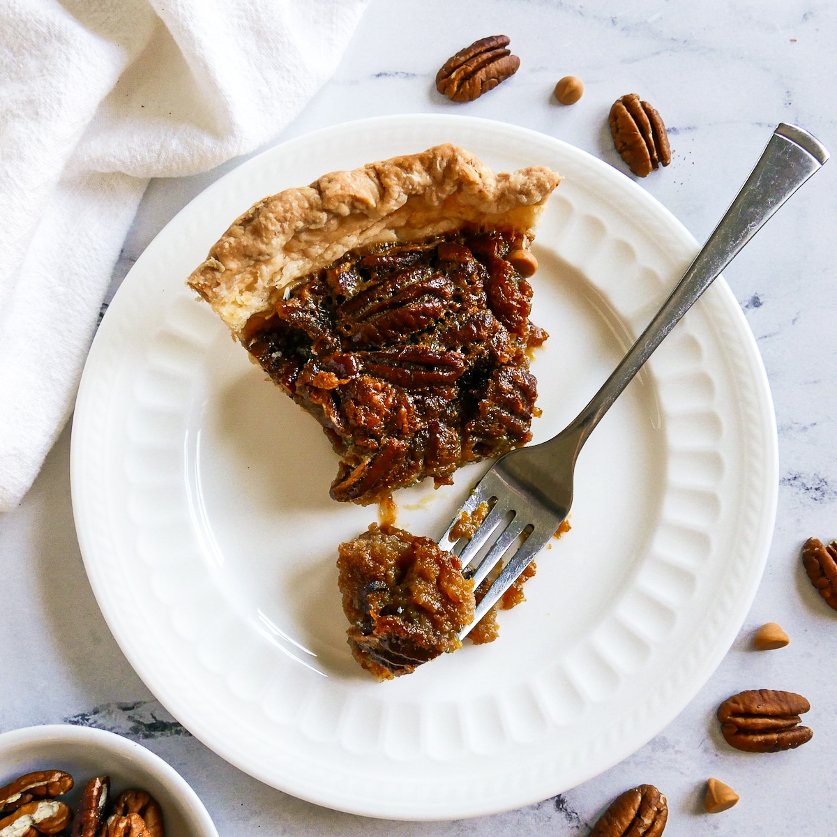 slice of pie with a fork on a white plate.