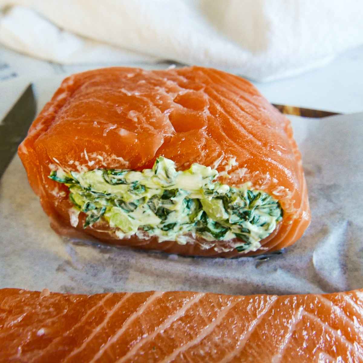 spinach filling stuffed into side pocket of salmon fillet.