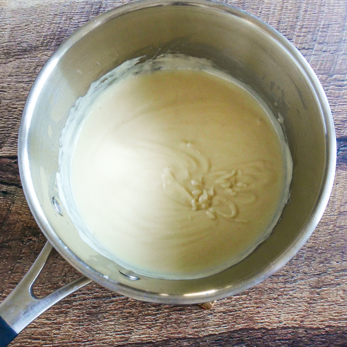 milk whisked into dip mixture in a saucepan.