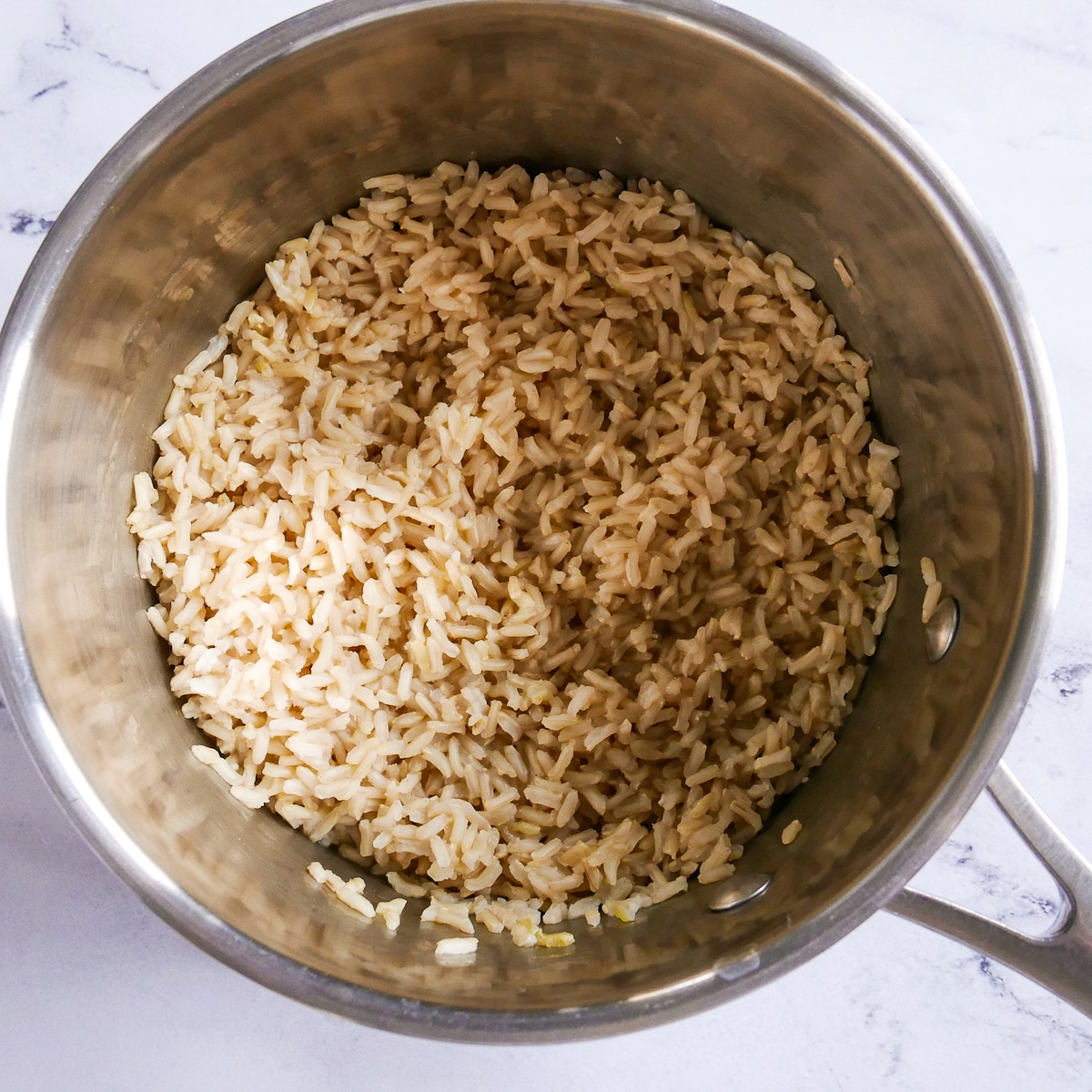 cooked brown rice in a saucepan.