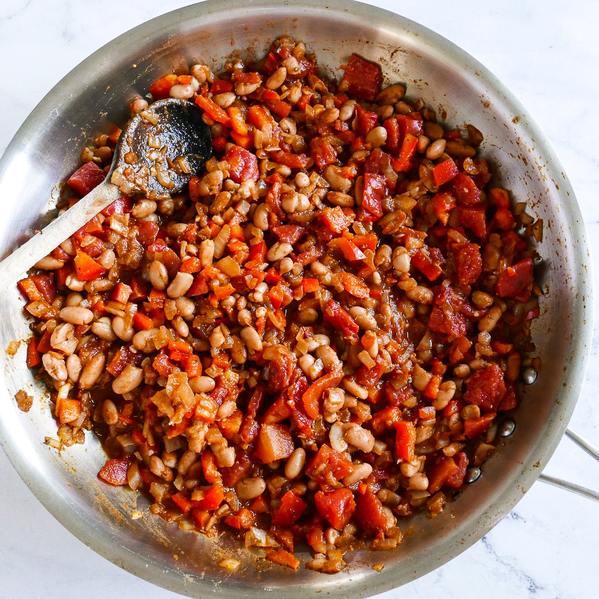 cooked pinto bean mixture with a wooden spoon.
