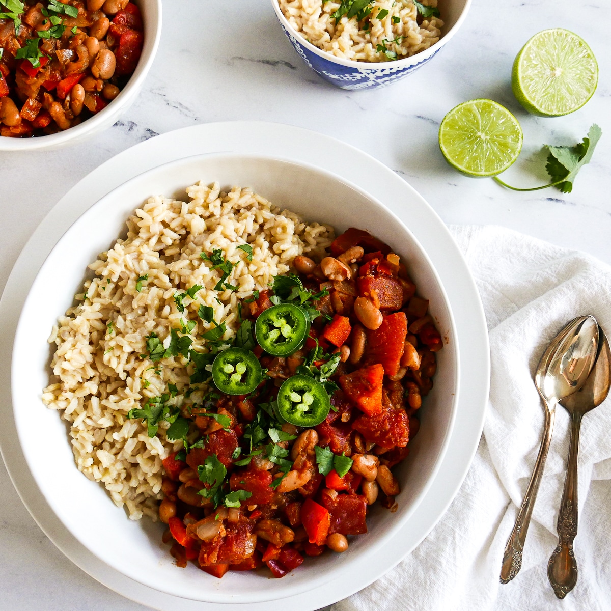 rice and pinto beans garnished with cilantro and jalapeno.