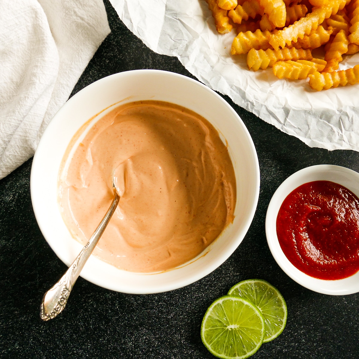 bowl of sriracha aioli with french fries.